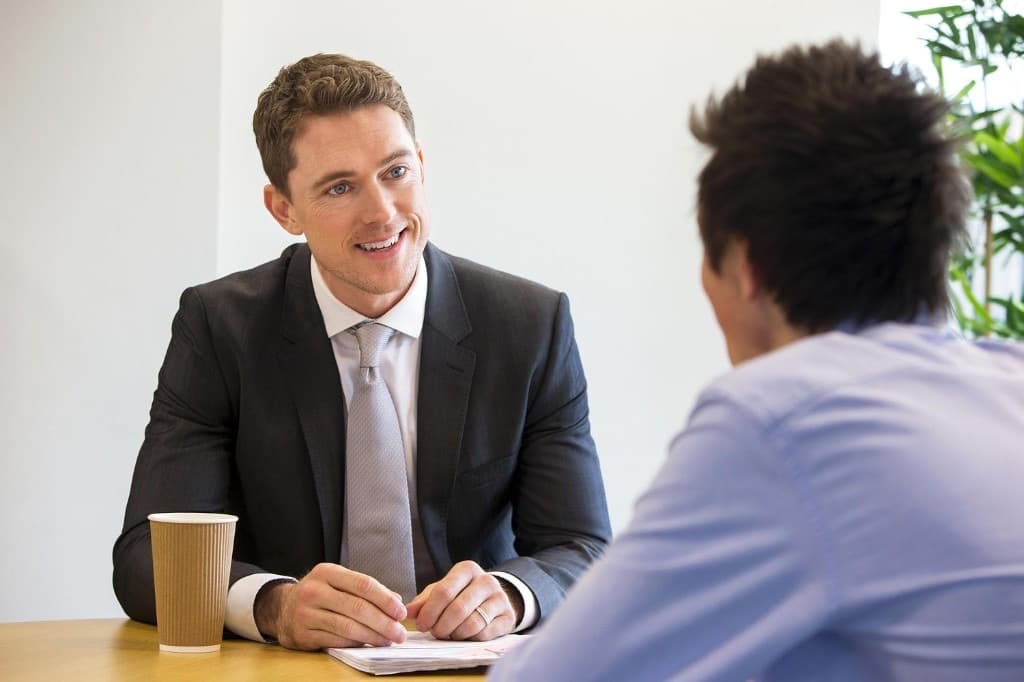 A recruiter speaking with a candidate during a professional interview